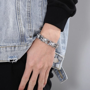 Silver punk skull bicycle chain bracelet in stainless steel worn by male model on street