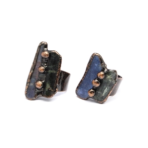Detailed close-up of vintage bronze rings featuring irregular natural ruby gemstones