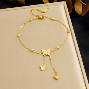 Close-up of gold-plated stainless steel bracelet with matte 3D butterfly charms