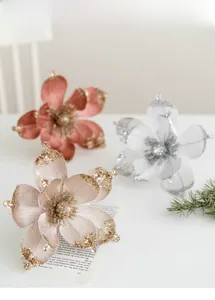 Close-up of glitter-edged magnolia flowers in champagne and silver for Christmas decor