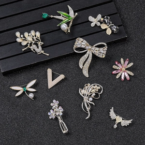 Elegant collection of crystal and pearl brooches with deer, leaf, and butterfly motifs