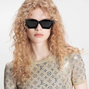 Detail shot of trendy irregular geometric black frame sunglasses worn by a stylish model