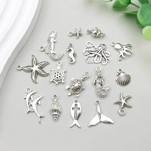 Detailed assortment of antique silver ocean charms including starfish and mermaids