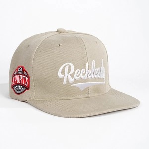 Khaki flat brim snapback hat featuring Reckless embroidery and USA Sports side patch