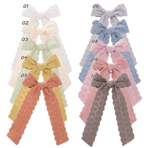 Detail showing ten color options of vintage lace ribbon bow hair clips with floral patterns