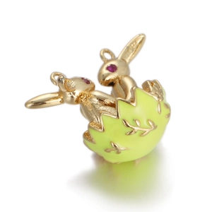 Detail of golden bunny Easter egg pendant with green enamel and intricate gold leaf patterns