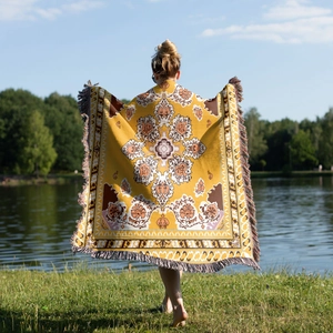 Detailed view of bohemian mandala throw blanket with elegant long tassels for picnic use