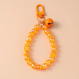 Detailed view of orange iridescent beaded keychain with metal clasp and matching bell charm