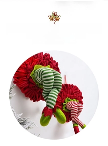 Detail of red and white striped Christmas elf legs with bells for festive door decor