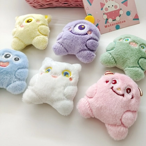 Colorful plush monster dolls in yellow, purple, and blue colors for bag decoration
