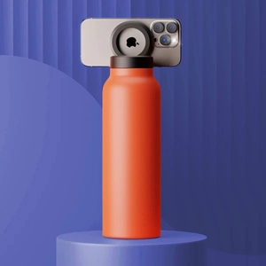 Detail of orange matte sports bottle with integrated magnetic phone mount on the lid