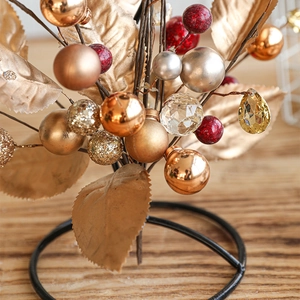 Christmas candle holder centerpiece with golden leaves, colorful baubles and crystal drops