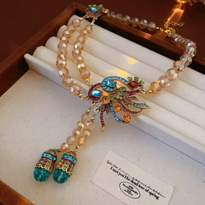 Detail of vintage flower necklace with colorful crystals and champagne glass beads