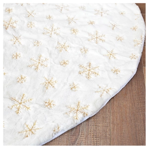 Close-up of plush white Christmas tree skirt with golden sequin snowflake embroidery