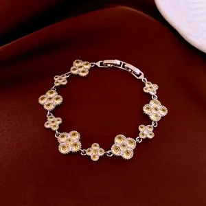 Silver flower bracelet featuring yellow zircon petals and fine beaded edge details