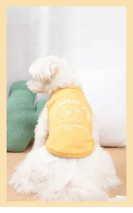 Detail view of yellow cotton pet vest with Rugby Star print on dog in home setting