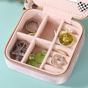 Pink velvet jewelry box with double zippers, interior compartments and a makeup mirror