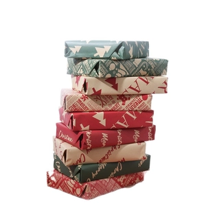 Nine stacked Christmas gift boxes wrapped in red and green kraft paper with holiday motifs