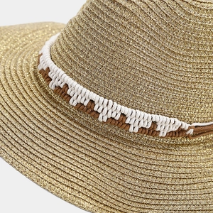 Close-up of golden metallic straw weave texture with dual-tone braided cotton rope detail