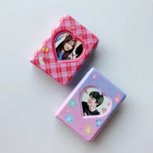 Detail of PVC mini photo albums with heart windows in pink and purple checkered patterns