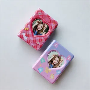 Detail of PVC mini photo albums with heart windows in pink and purple checkered patterns