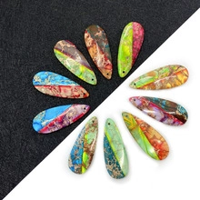 Macro shot of colorful stone heart-shaped charms with natural marble texture and top holes