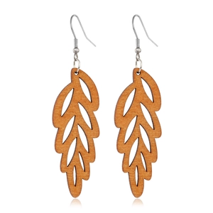 Detailed close-up of hollow leaf-shaped brown wooden earrings with metal hooks