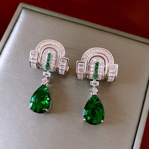 Detail of silver drop earrings with green teardrop crystal and sparkling zircon accents