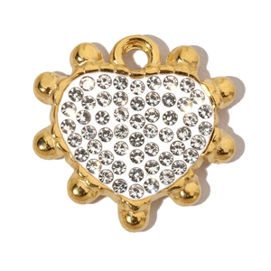 Detailed macro shot of a heart-shaped gold pendant with sparkling inlaid rhinestones