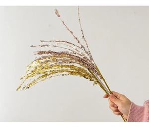 Detail of glitter branch ornaments in gold and pink purple for festive tree decor
