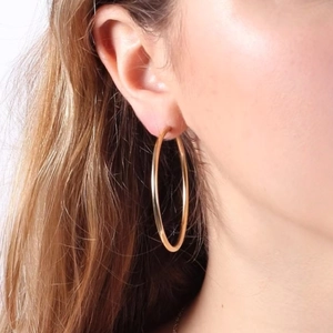 Minimalist large gold hoop earrings with a sleek metallic finish for a daily chic look