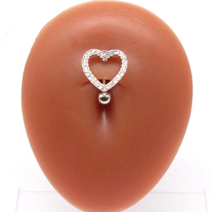 Silver heart belly button ring with rhinestones on a silicone model navel piercing