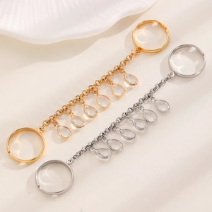 Detailed shot of gold and silver finger bracelet with chain and water drop pendants
