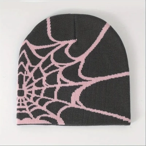 Close-up of spider web jacquard pattern on dark grey and pink knitted beanie hat