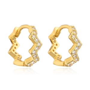 Macro shot of gold-plated wavy hoop earrings with embedded sparkling cubic zirconia