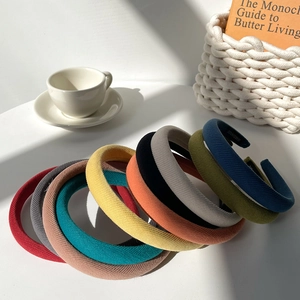 Minimalist wide sponge headbands in multiple colors stacked with a cozy lifestyle vibe