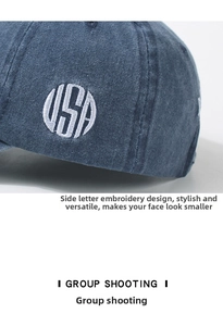 Close-up of USA embroidery detail on washed navy blue cotton baseball cap fabric