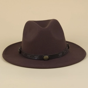 Detailed close-up of a brown fedora hat featuring a leather band with vintage metal buckles