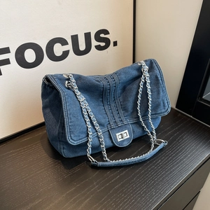 Vintage denim blue tote bag with metallic chain strap and classic turn-lock closure
