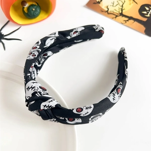 Detail of Halloween knot headband with skull pattern and pearls on a white plate