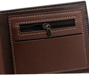 Detail of a brown leather wallet showing the metal zipper pocket and stitched card slot