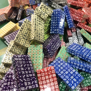 Close-up of colorful acrylic dice charms piled in bulk for DIY keychain making
