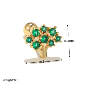 Detailed macro view of 10.5mm gold tree of life stud earring with green cubic zirconia