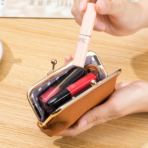 Brown genuine leather mini coin purse with metal clasp and polka dot lining in use