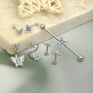 Silver butterfly piercing set with blue enamel and rhinestones on stone decor