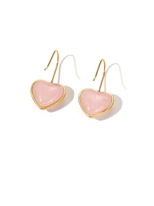 Close-up of pink translucent heart drop earrings with elegant gold metallic hooks