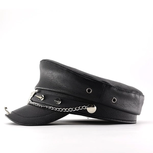 Close-up of black PU leather flat-top cap with silver chains and metallic rivets detail