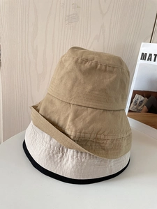 Foldable cotton bucket hats in khaki, cream and black showing stitched brim details