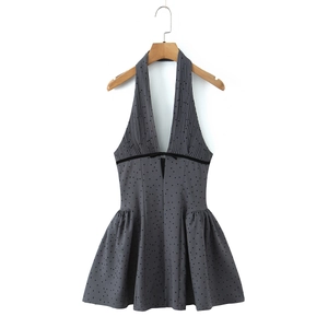 Gray halter neck dress with black flocked polka dots and a deep V-neck waist tie