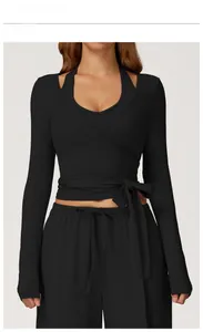 Front view of black yoga set featuring cross-waist wrap top and matching leggings